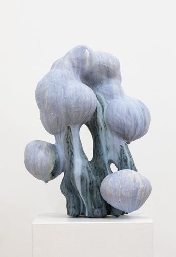 Ceramic sculpture with light purple and blue marbled glaze. The sculpture is an arch-like shape with cloud-like forms attached.