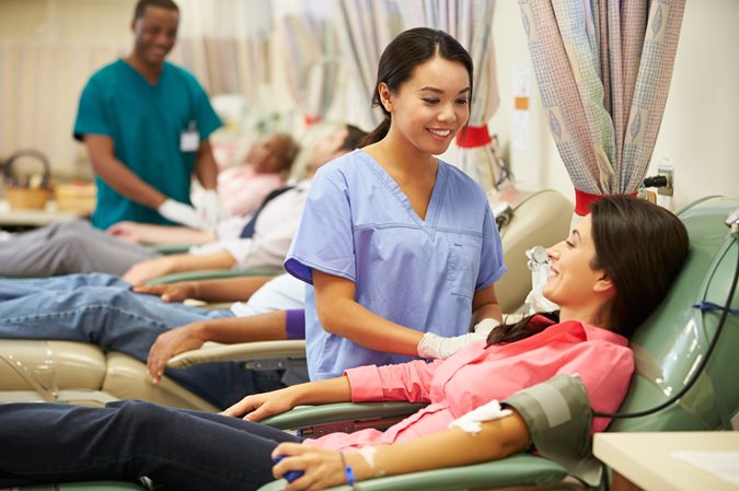 Phlebotomists working with patients