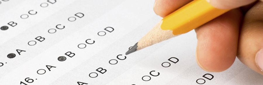 Student filling out multiple choice scantron answer sheet
